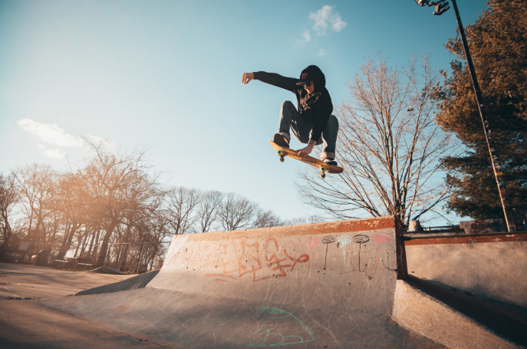 Skate board jumping on ramp