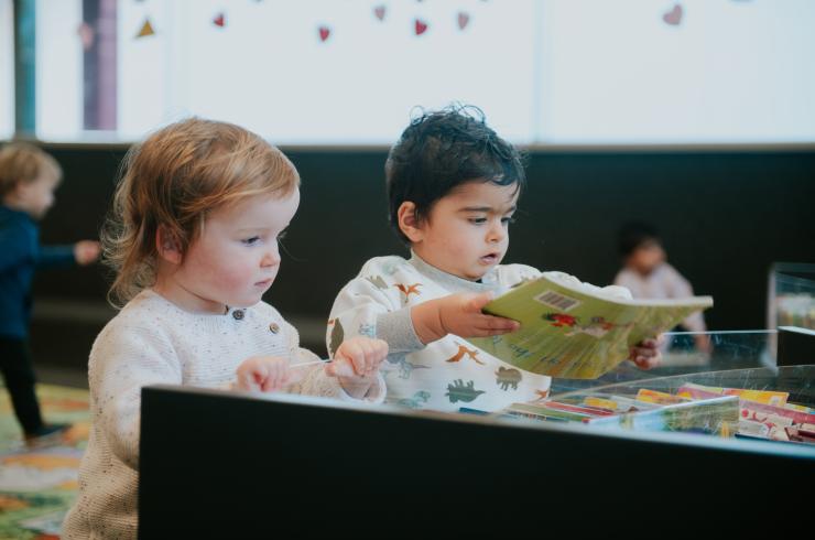 Two young children at a Storytime session.