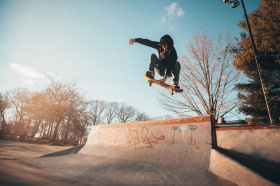 Skate board jumping on ramp